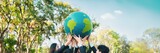 Earth day concept with big Earth globe held by group of asian business people team promoting environmental awareness with environmentally sustainability and ESG principle for brighter future. Gyre