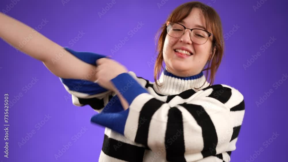 Portrait of strong laughing young woman 20s years old showing muscles biceps isolated on purple background in studio. People lifestyle concept. Portrait of strong laughing young woman 20s years old showing muscles biceps isolated on purple background in studio. People lifestyle concept.