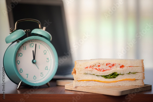 Sandwich and alarm clock di...