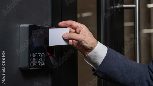 A man opens the door with a card. Modern electronic lock. Keyless Entry photo