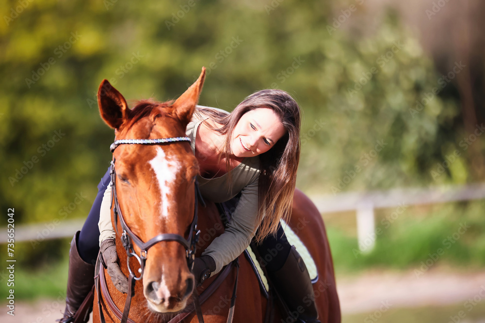 Obraz premium Horse woman rider riding in the sunshine at the riding arena.