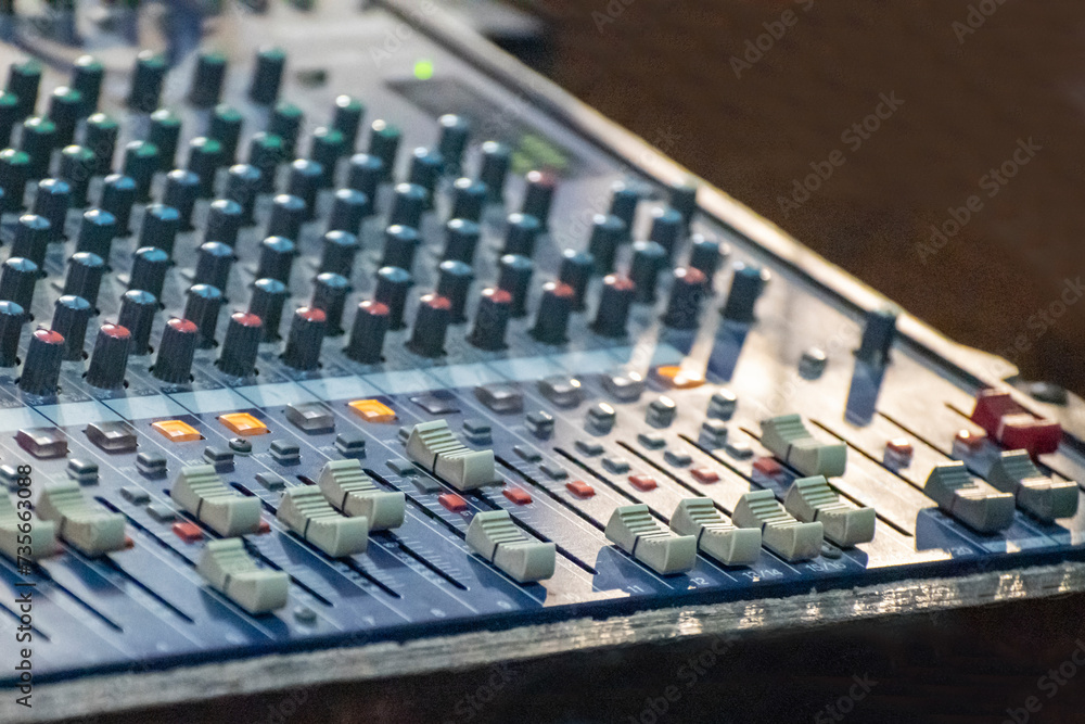 Obraz premium Sound engineer using mixing console to produce a sound track.