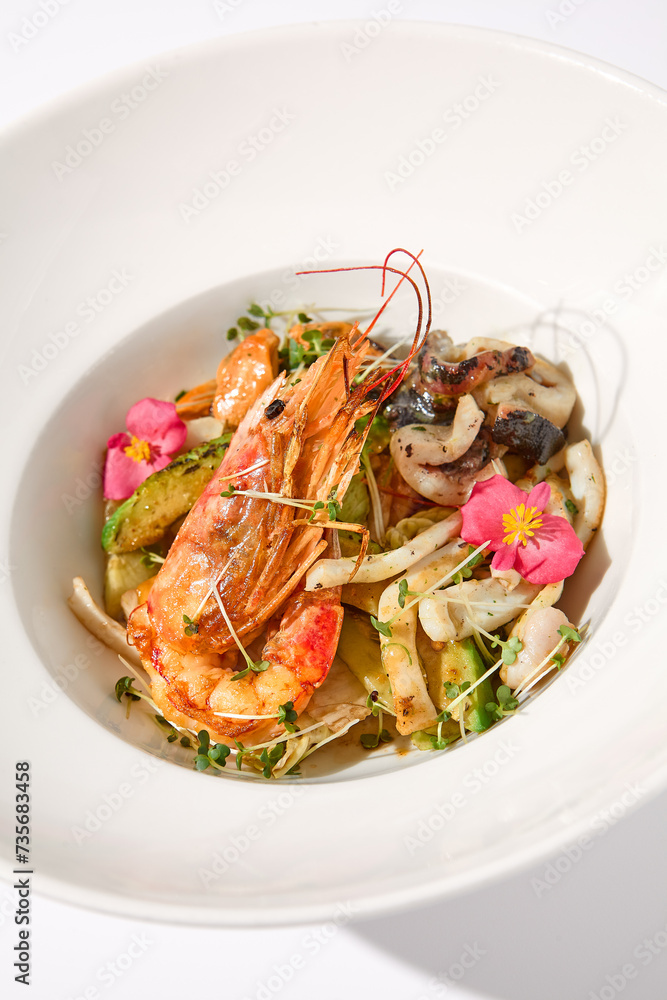 Saute seafood in zucchini with a decorative plating on a white backdrop Saute seafood in zucchini with a decorative plating on a white backdrop