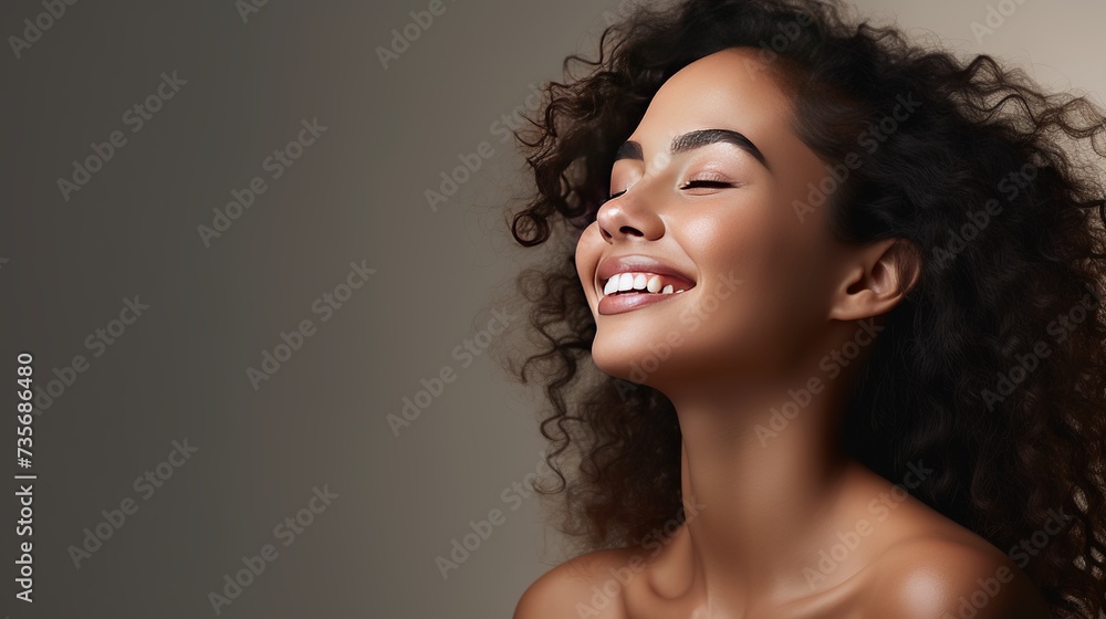 Portrait of beautiful latin woman touching her clean and healthy face against grey background. Smiling hispanic woman with natural makeup feeling healthy skin with eyes closed. Beauty care Portrait of beautiful latin woman touching her clean and healthy face against grey background. Smiling hispanic woman with natural makeup feeling healthy skin with eyes closed. Beauty care