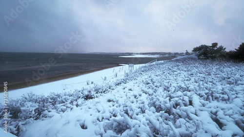 Cape Cod in Winter with Snow at Sunset on the Beach photo
