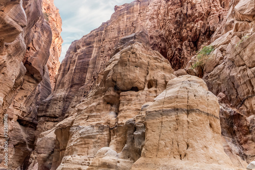 The extraordinary beauty of high mountains on sides of gorge of the tourist route of the gorge Wadi Al Ghuwayr or An Nakhil and the wadi Al Dathneh near Amman in Jordan