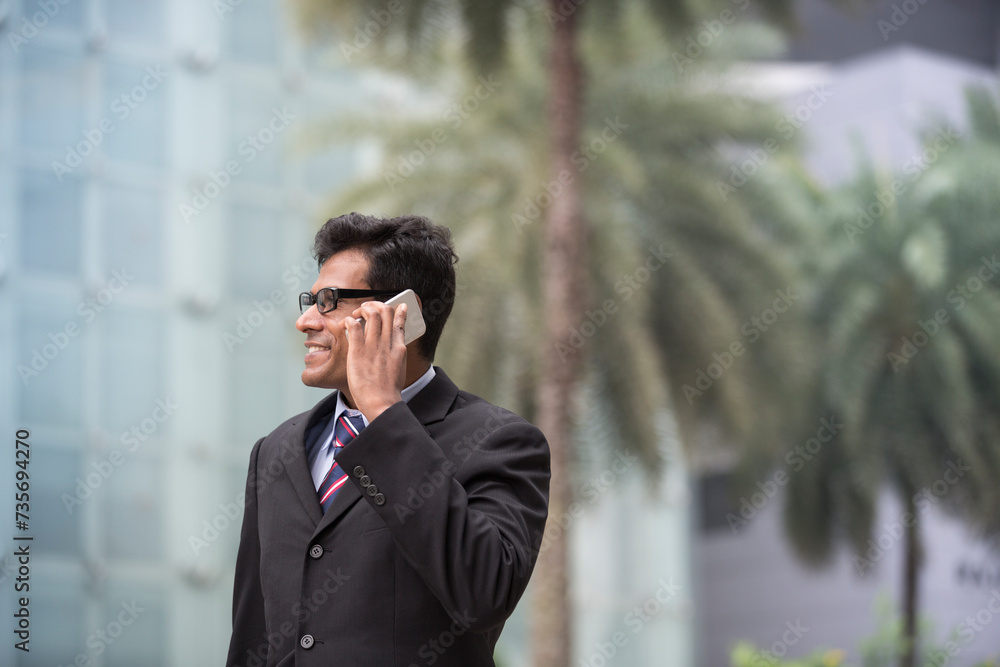 Indian business man talking on his Smart phone. Indian business man talking on his Smart phone.