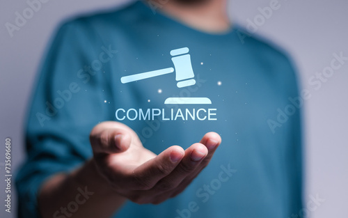 Compliance rules and law regulation policy concept. Person holding compliance icon on virtual screen. photo