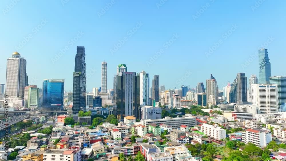 4K - Bangkok Thailand: Drone Aerial view, Over the urban sprawl, a drone surveys the vibrant pulse of the business district. High-rises punctuate the skyline, symbols of bustling commerce below.
4K - Bangkok Thailand: Drone Aerial view, Over the urban sprawl, a drone surveys the vibrant pulse of the business district. High-rises punctuate the skyline, symbols of bustling commerce below.