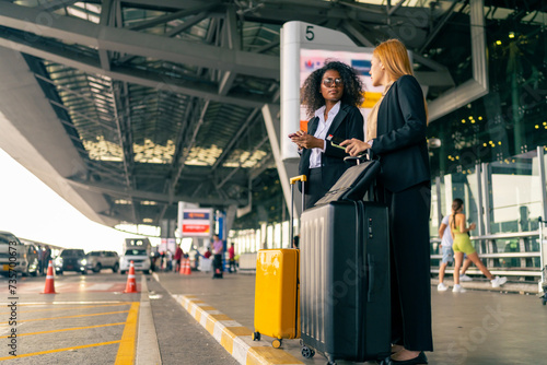 Wallpaper Mural Executive businesswoman colleague with luggage trolley waiting for taxi go to hotel in the city together at airport terminal. Business travel, holiday vacation and public transportation concept. Torontodigital.ca