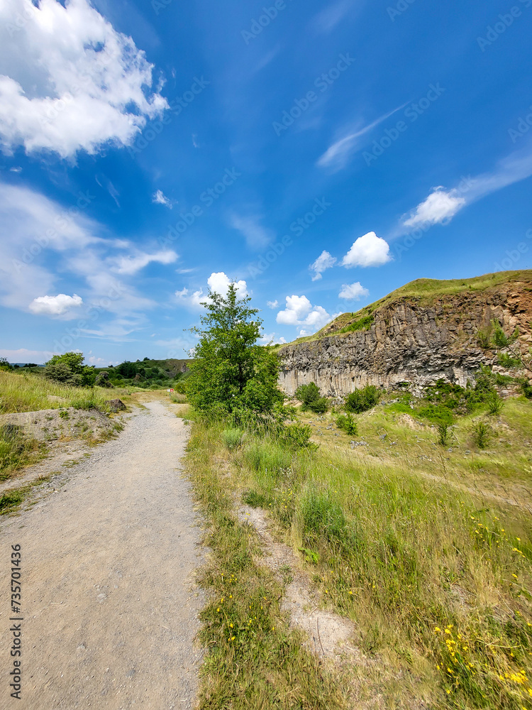 The basalt columns of Racos, Coloanele de bazalt de la Racos, stone wall in nature with blue sky, Racos, Brasov, Transylvania, Romania