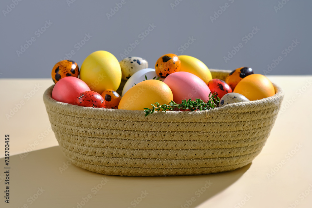 Easter colored eggs in a wicker basket. Easter composition. Easter colored eggs in a wicker basket. Easter composition.