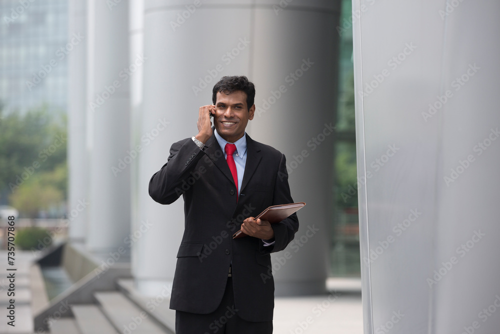 Indian business man talking on his Smart phone. Indian business man talking on his Smart phone.
