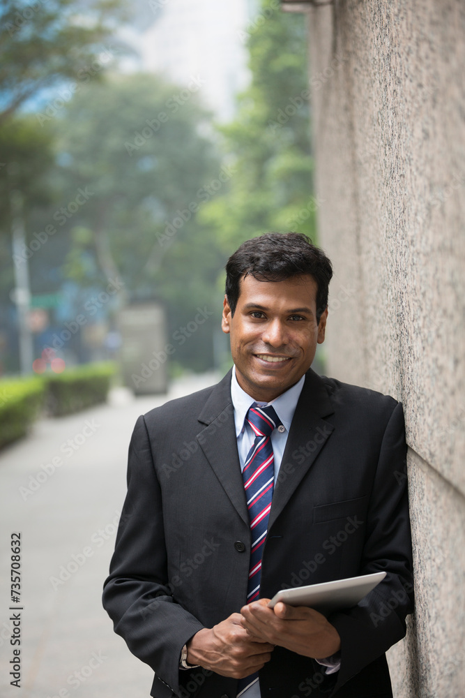 Indian businessman using digital tablet computer. Indian businessman using digital tablet computer.