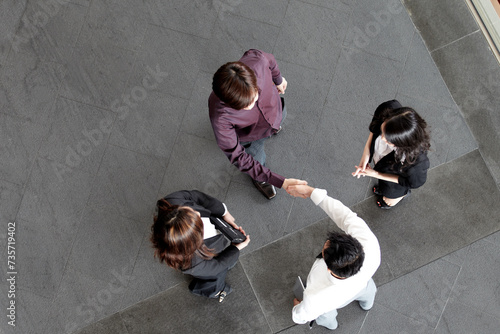 High angle view of Asian Business people shaking hands.