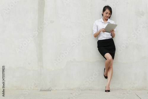 Asian Business woman using a Touch-Pad PC