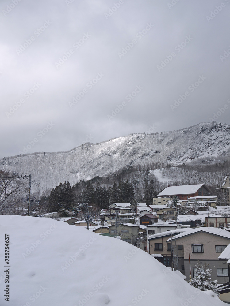 Zao onsen famous hot spring area winter view with small city and mountains 