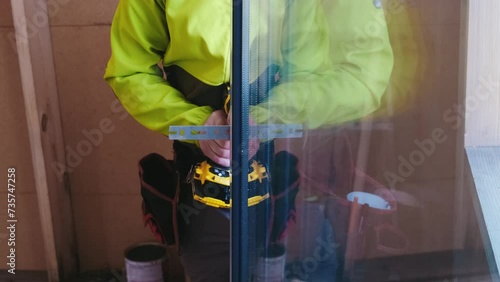 The experienced carpenter expertly fits glass panes into frames.