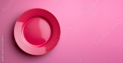 Minimalist Pink Ceramic Plate on a Vibrant Pink Background with Ample Copy Space