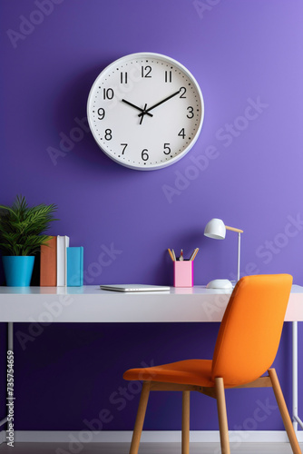 A minimalistic office mockup with a clean, white work desk, a pop of vibrant purple in the chair, and a colorful wall clock.