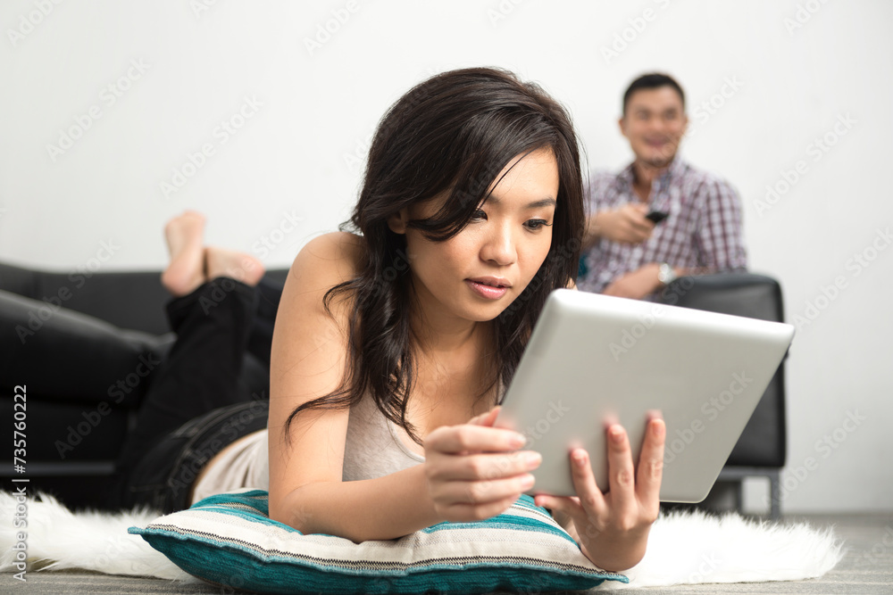 happy Asian woman using Digital Tablet at home happy Asian woman using Digital Tablet at home