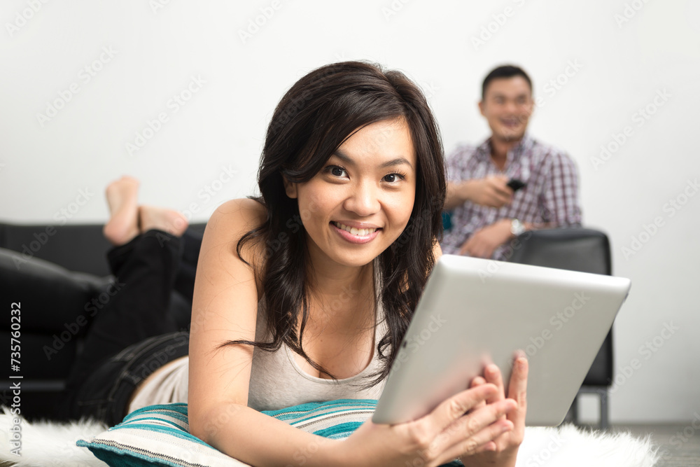 happy Asian woman using Digital Tablet at home happy Asian woman using Digital Tablet at home