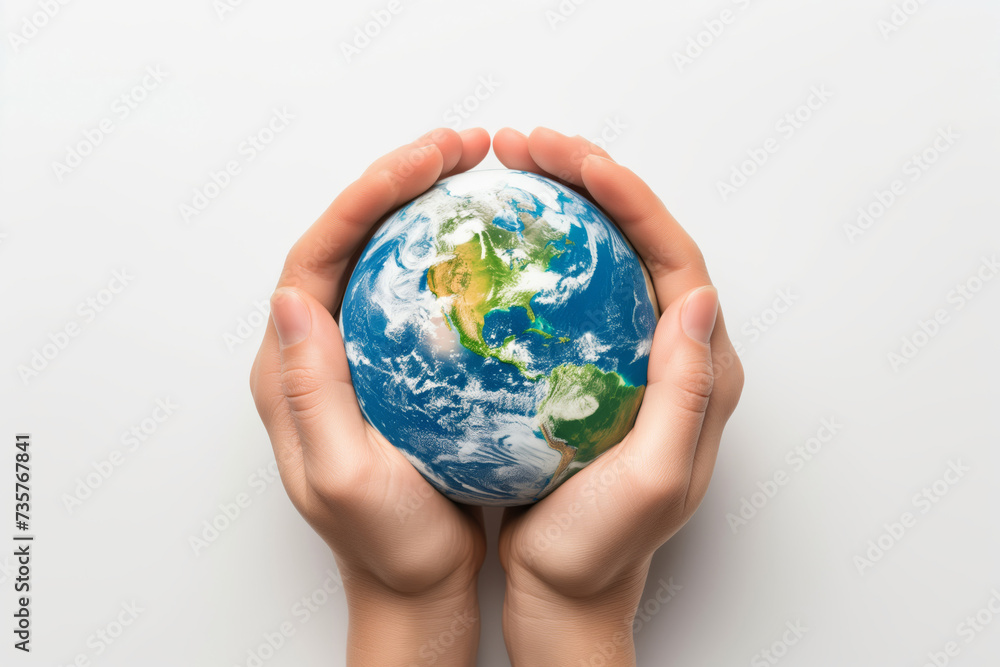 Miniature planet Earth in hand against a background of grass sky and sun Miniature planet Earth in hand against a background of grass sky and sun