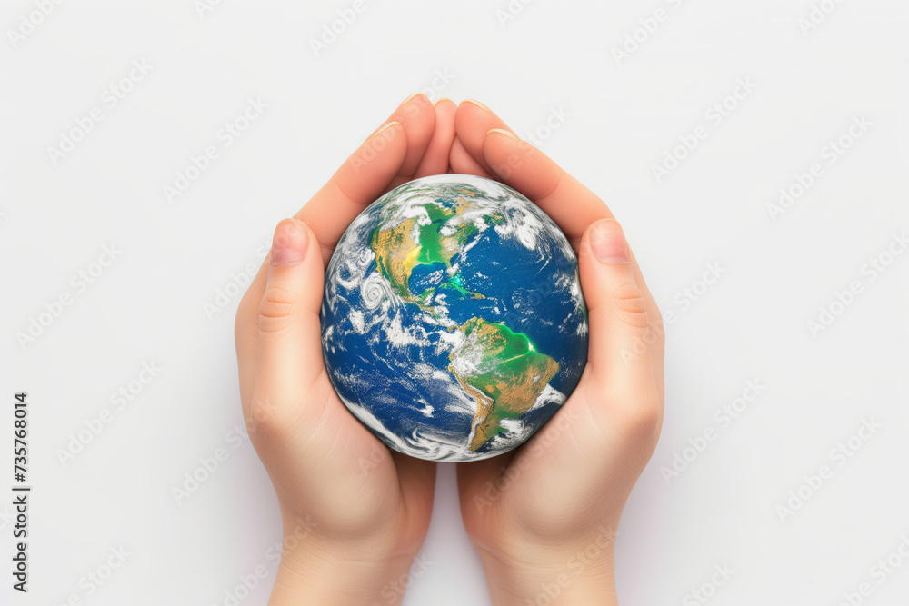 Miniature planet Earth in hand against a background of grass sky and sun Miniature planet Earth in hand against a background of grass sky and sun