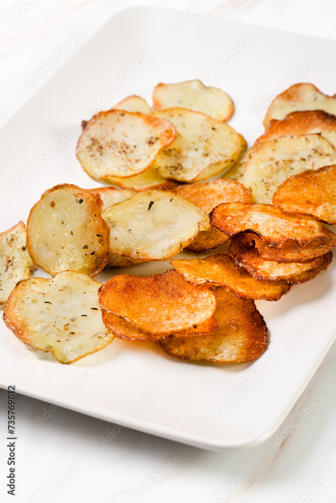Homemade Potato Chips on black Board Homemade Potato Chips on black Board