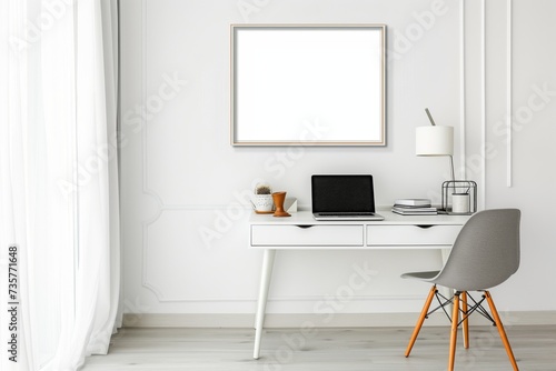 bright room, frame above a white desk with a laptop and a chair © studioworkstock