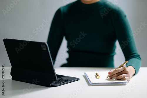 businesswoman hand working with new modern computer and writing on the notepad strategy diagram