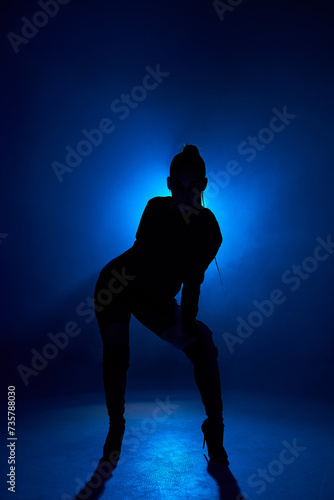 Freedom. Dancing in blue dark room. Sexy woman's portrait on isolated background in smoky neon. passionate model. Concept of human emotions, performance, dance, go go dance, fashion. Motion, action