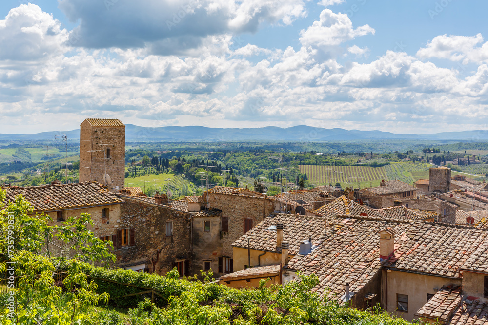 View of houses against an Italian rural landscape