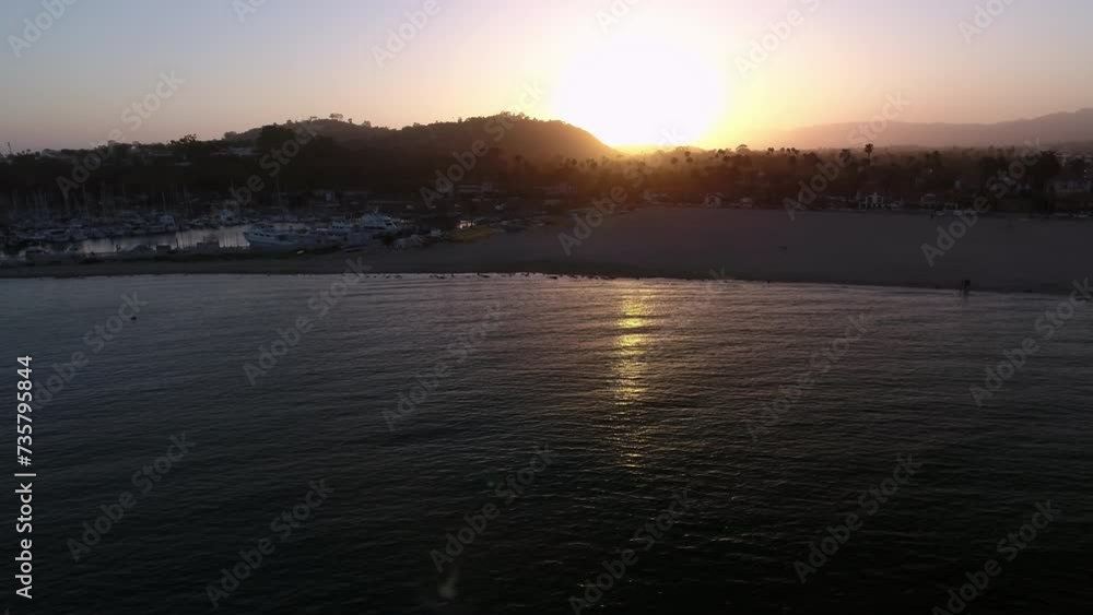 Aerial: Panning Scenic View Of Harbor At Beach Against Clear Sky, Drone Flying Over Wavy Sea During Sunset - Santa Barbara, California Aerial: Panning Scenic View Of Harbor At Beach Against Clear Sky, Drone Flying Over Wavy Sea During Sunset - Santa Barbara, California