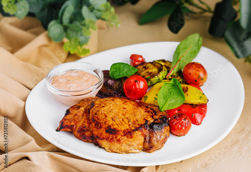 Fototapeta Naklejka Na Ścianę i Meble -  pork ribs with potatoes and pork steak with grilled vegetables