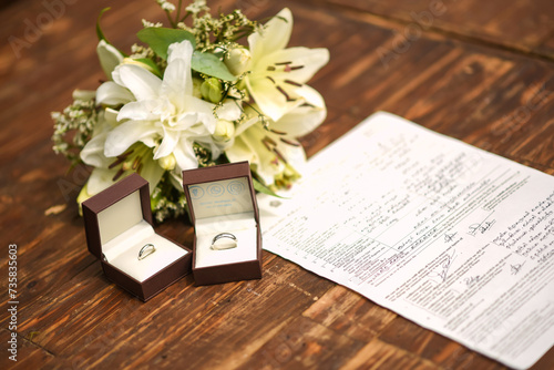Amazing close up view of Engagement rings with flower bouquet and marriage certificate