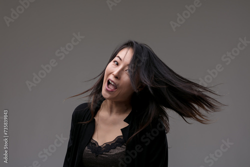 Hair swirls as laughter captures joyful essence