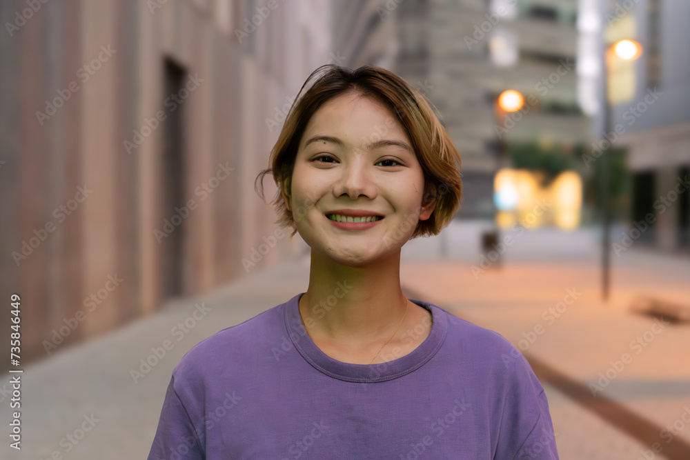 Portrait of a happy young woman outdoor. Close up of a smiling chinese girl in the city. Female looking at camera with kindly expresion Portrait of a happy young woman outdoor. Close up of a smiling chinese girl in the city. Female looking at camera with kindly expresion