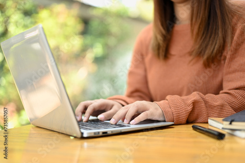 Young woman browsing internet, remote work or stying online on laptop at home