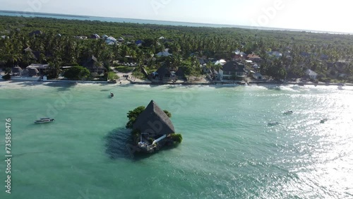 Zanzibar shoreline with house out in the water, tanzania, africa photo