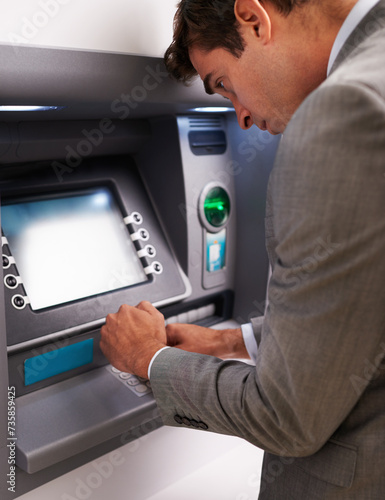 Businessman, ATM and typing pin for cash withdrawal, security or privacy in financial safety at money machine. Man in business suit on electronic banking system for deposit, investment or finance
