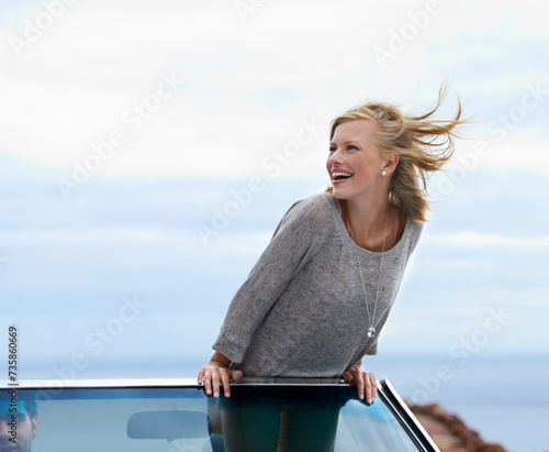 Happy, blue sky and convertible car with woman on road trip for travel, vacation or holiday in summer. Space, smile and journey with young person driving in vehicle for transport in fresh air