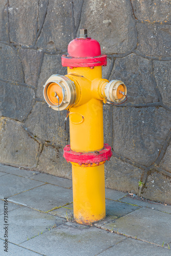 Yellow and red fire hydrant on the street