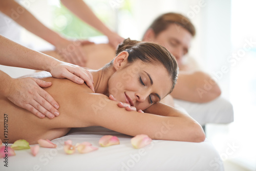 Couple, massage and relax in luxury spa with treatment on body for wellness on holiday or vacation. Beauty, care and calm people together in hotel, salon or resort for healthy skincare on back