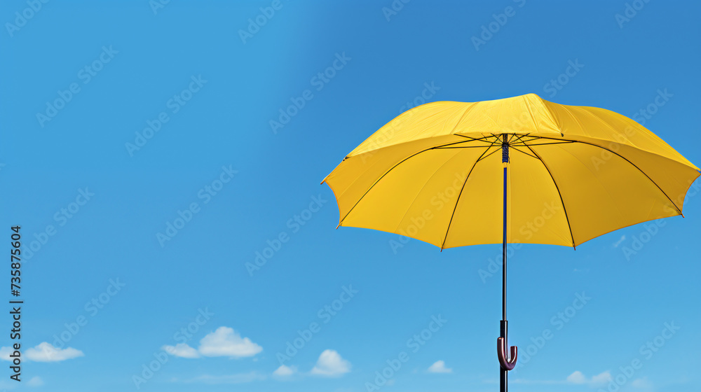 A yellow umbrella sitting on top of a wooden basket