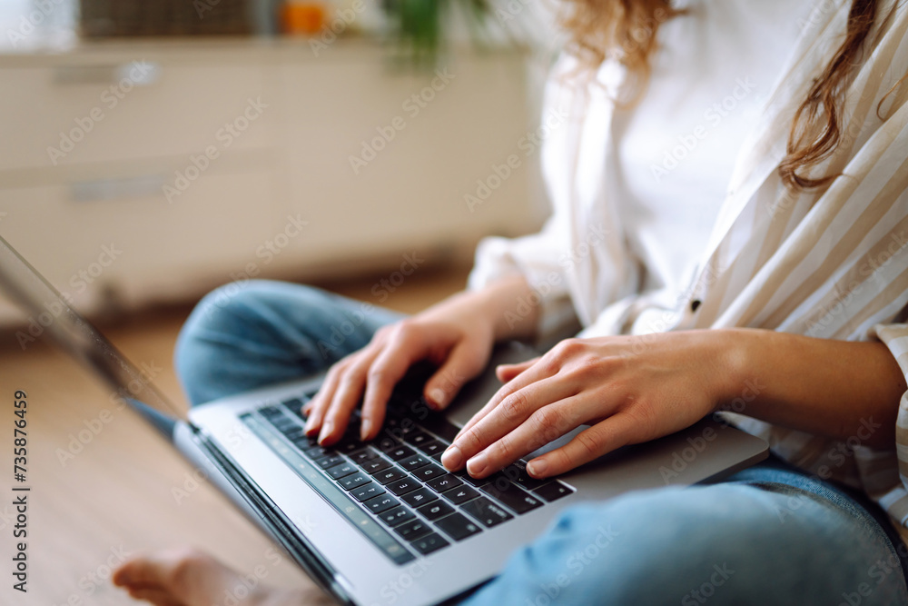 Fototapeta premium Close-up of hands working on a laptop keyboard. Concept of using the Internet and modern wireless technologies. Cyber security concept