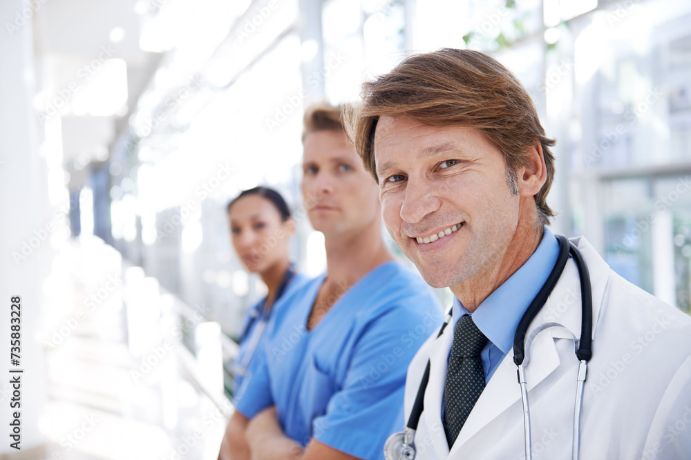 Teamwork, doctors and portrait of man in hospital for medical service, insurance and support. Healthcare, clinic and face of happy men and women in hallway for collaboration, consulting and medicine Teamwork, doctors and portrait of man in hospital for medical service, insurance and support. Healthcare, clinic and face of happy men and women in hallway for collaboration, consulting and medicine