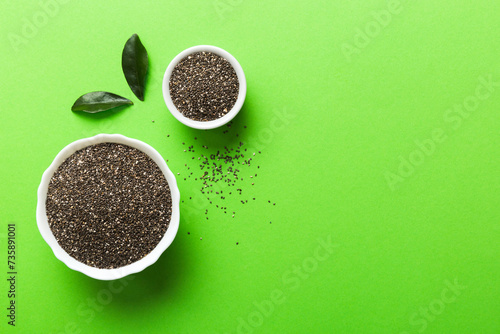 Chia seeds in bowl on colored background. Healthy Salvia hispanica in small bowl. Healthy superfood photo