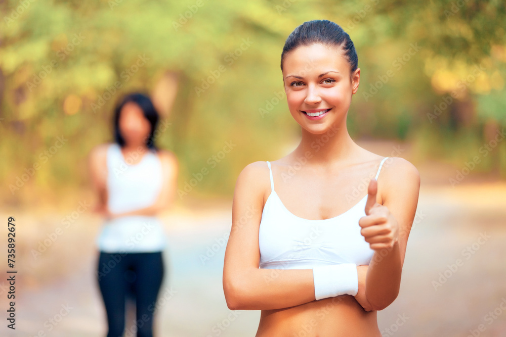 Fototapeta premium Outdoor, fitness and portrait of woman with thumbs up in woods or forest for exercise. Workout, achievement and girl smile in summer, nature or park with happiness, pride and runner sign for yes
