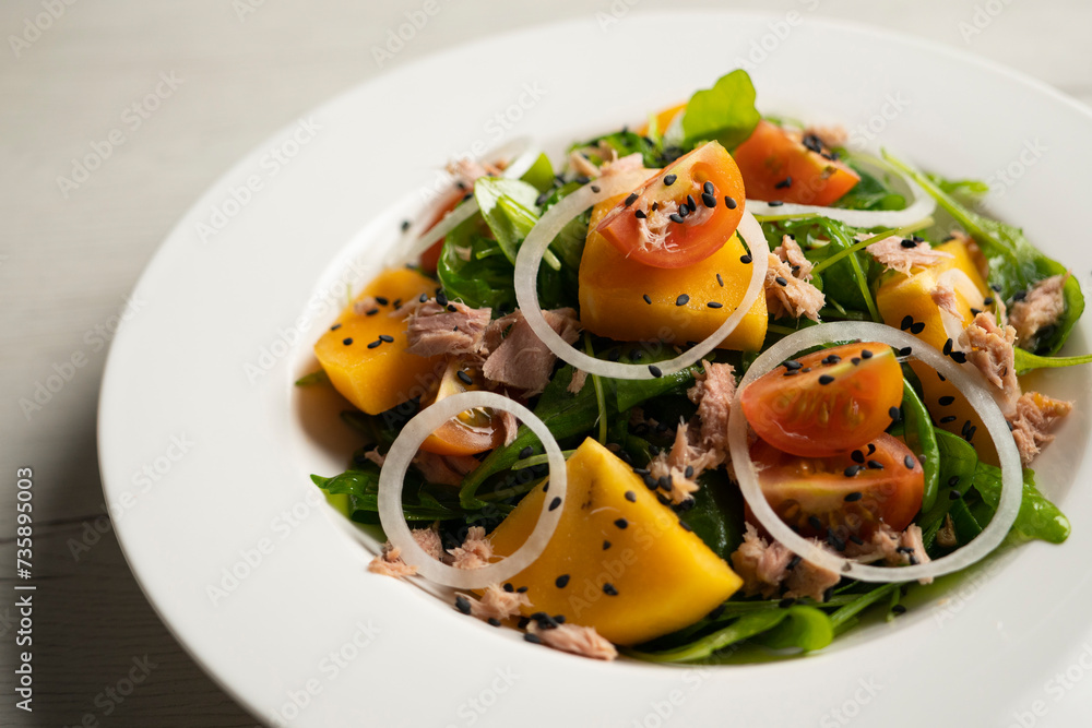 Persimmon, tomato, onion and tuna salad. Persimmon, tomato, onion and tuna salad.